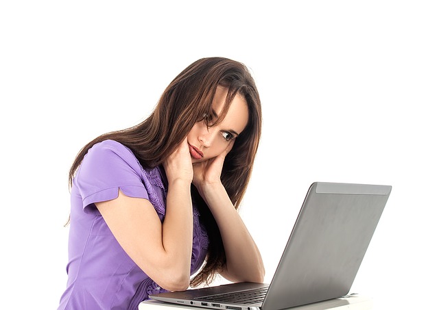 Fatigued Women Leaning Over Laptop